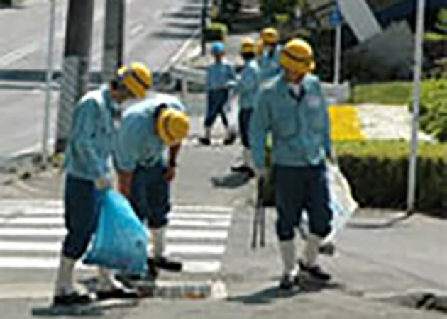 市内の歩道を清掃する新入社員