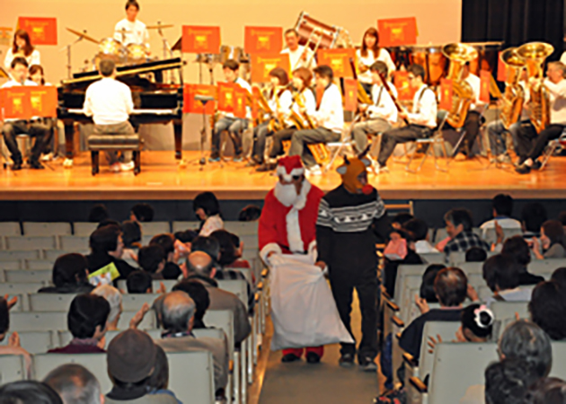 吹奏楽団が演奏するなか、お菓子をプレゼント